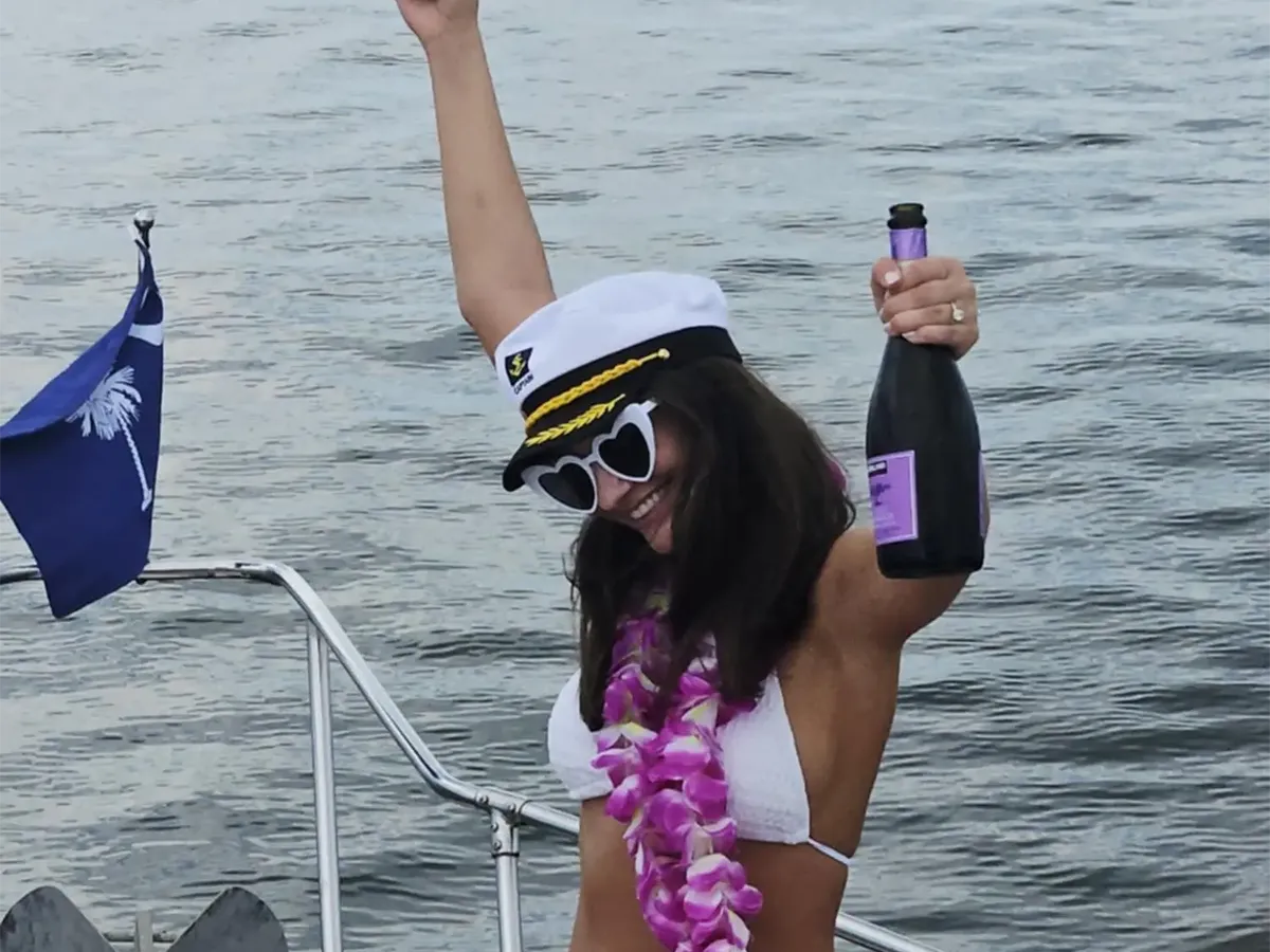 Guest celebrating with a bottle of wine aboard Southern Wonder Yacht